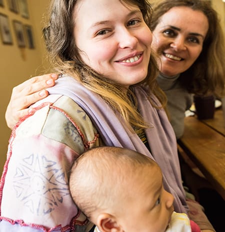 Midwives continue their support. New mom with baby & midwife